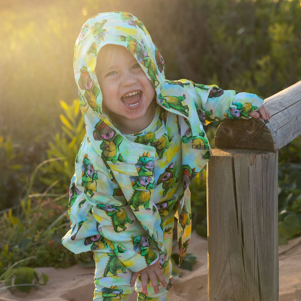 Cheeky Little Boy Wearing Dinosaur Koala Raincoat