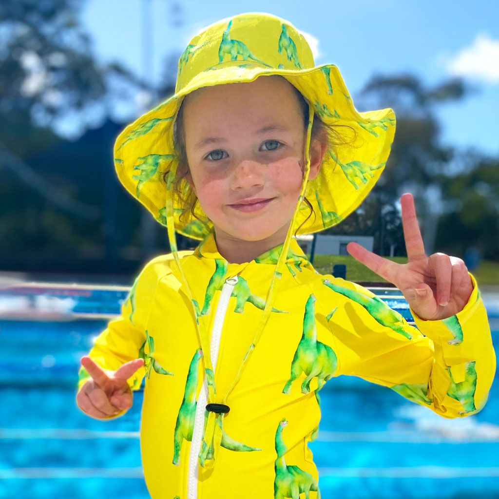 Girl Wearing Fluro Dinosaurs Beach Hat