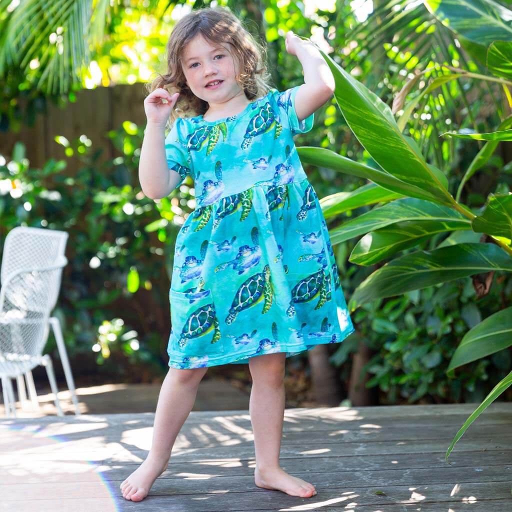 Girl Wearing Blue Turtle Short Sleeve Pocket Dress
