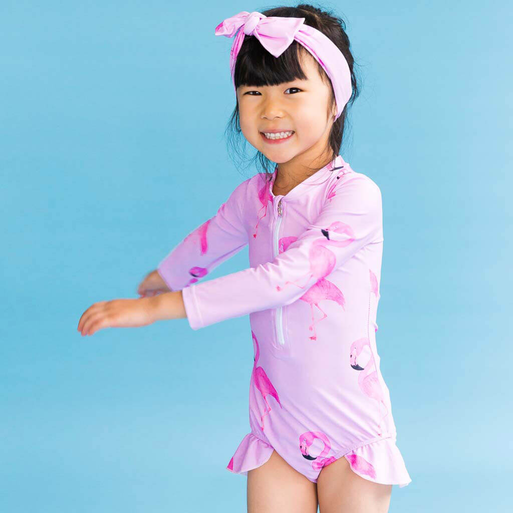 Girl Wearing Flamingo Girls Long Sleeve Zip Swimmers