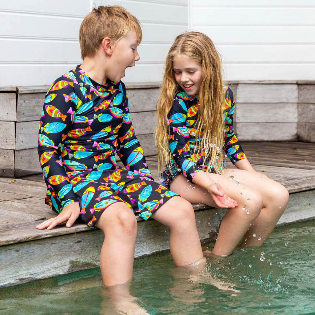 Boy Sitting On Pool Edge Wearing Neon Fish Kids' Rash Top