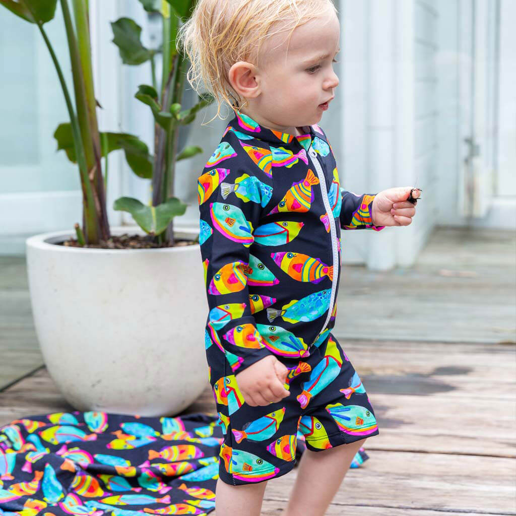Toddler Standing Wearing Neon Fish Unisex Long Sleeve Zip Swimmers
