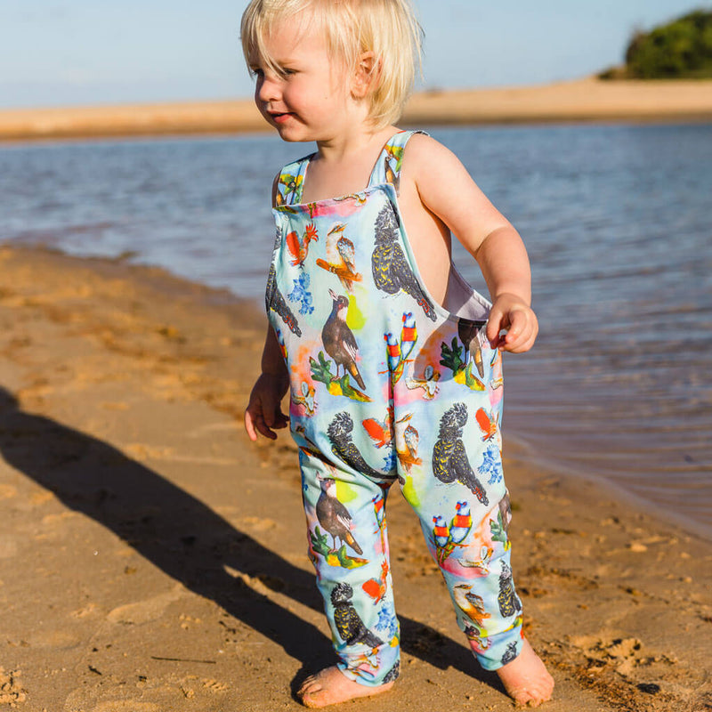 Little Boy At Beach Wearing Feathered Friends Long Leg Overalls