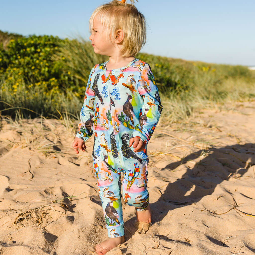 Little Boy Wearing Feathered Friends Long Sleeve Double Zip Sleepsuit