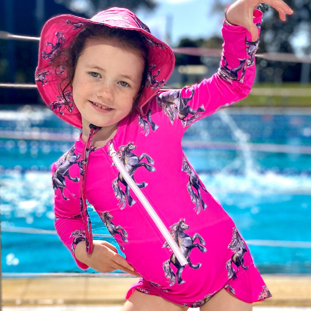 Girl Posing Wearing Fluro Horses Girls Long Sleeve Zip Swimmers