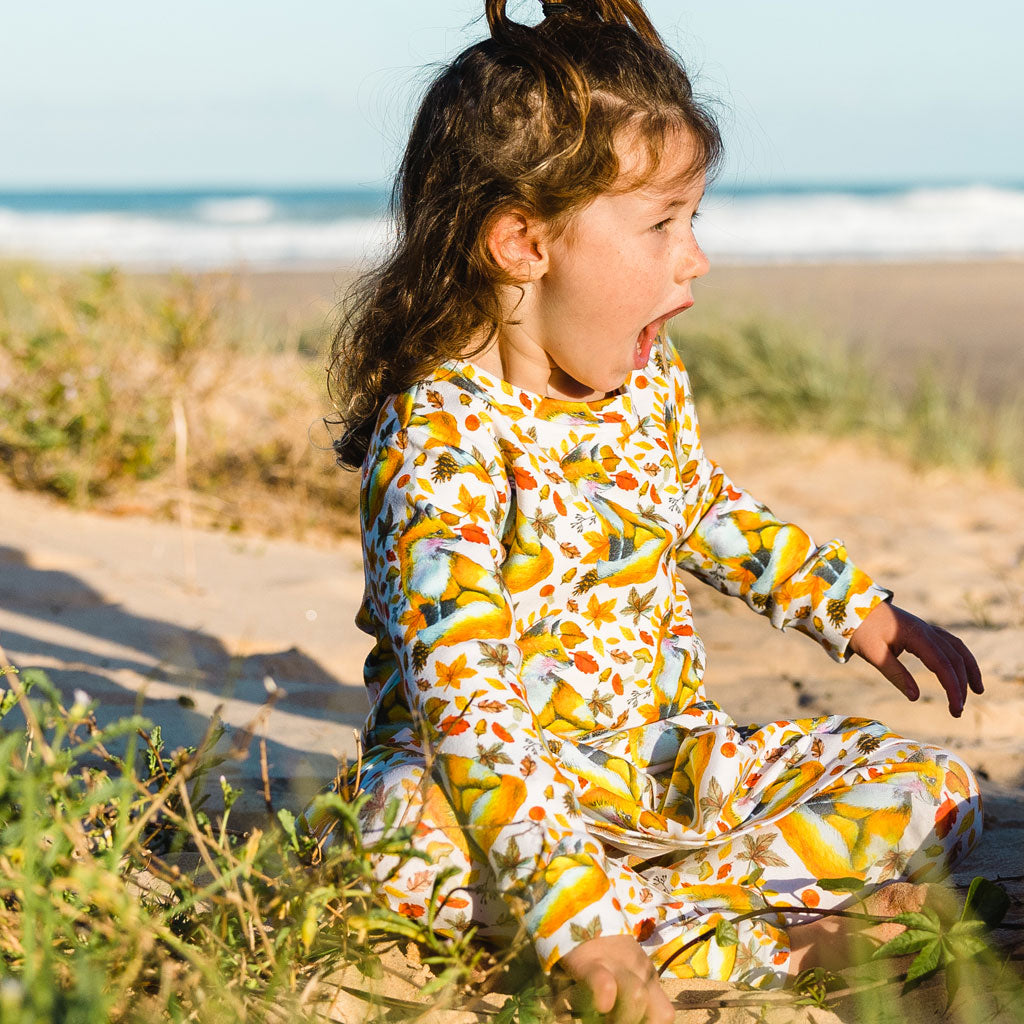 Little Girl Sitting on Beach Wearing Products Maple Fox Kids' Jumper
