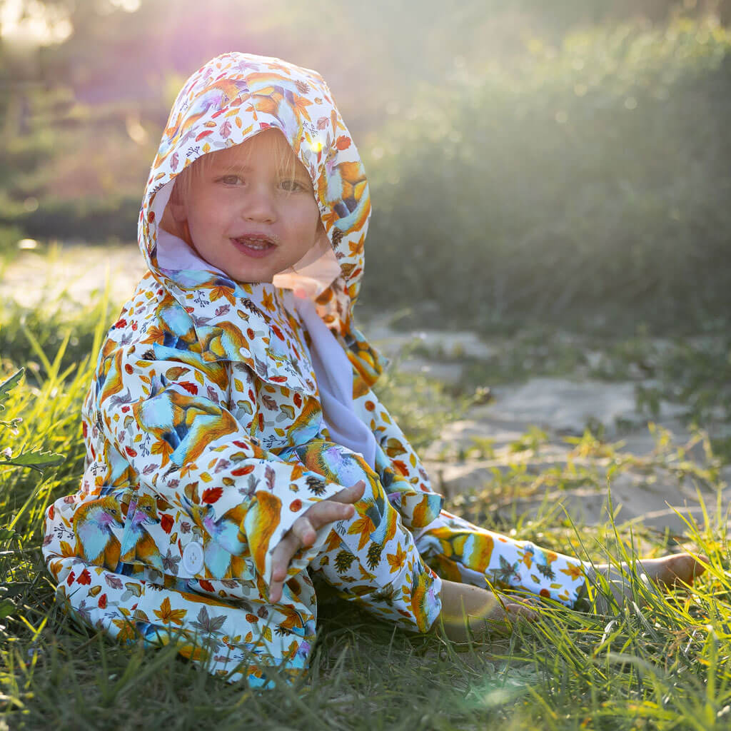 Little Boy Sitting Wearing Maple Fox Raincoat