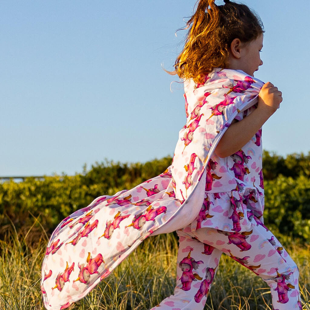 Girl Wearing Unicorn Koala Blanket As Cape