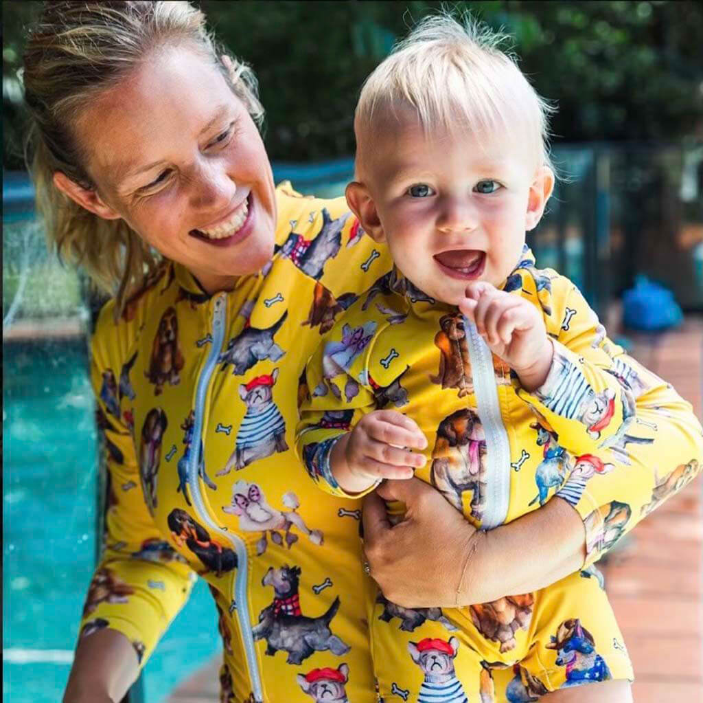 Woman Poolside Holding Toddler While Wearing Best Mates Women's Long Sleeve Zip Swimsuit