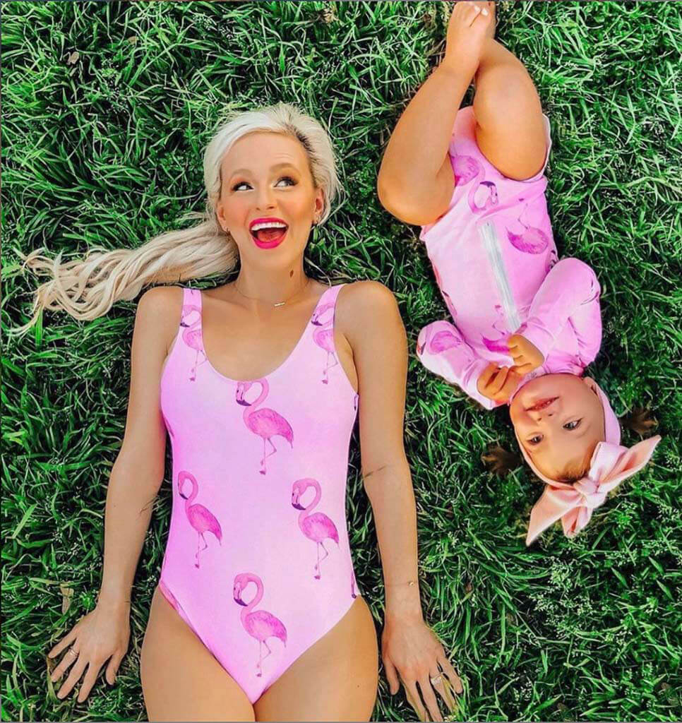 Woman Laying On Grass With Little Girl While Wearing Flamingo Women's One Piece Swimmers
