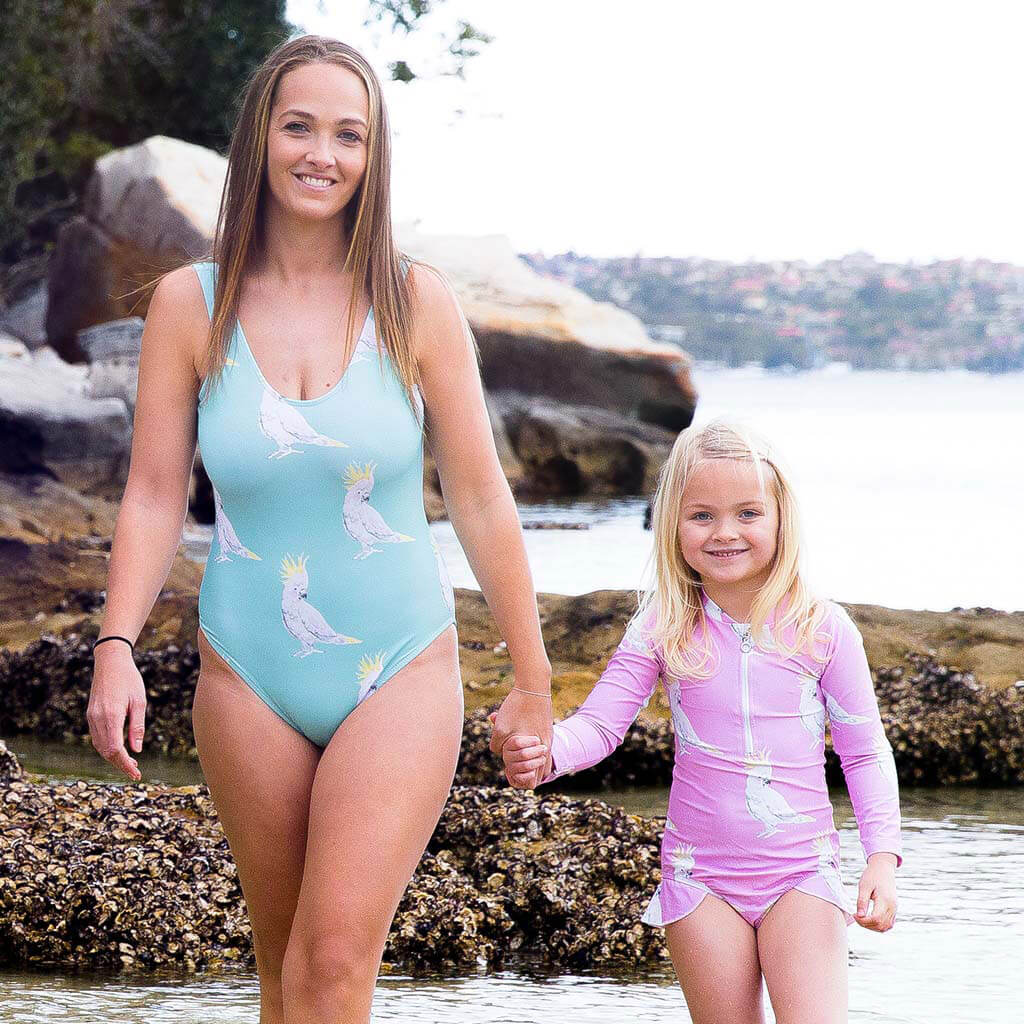 Woman Wearing Green Cockatoo Women's One Piece Swimmers On Beach With Little Girl