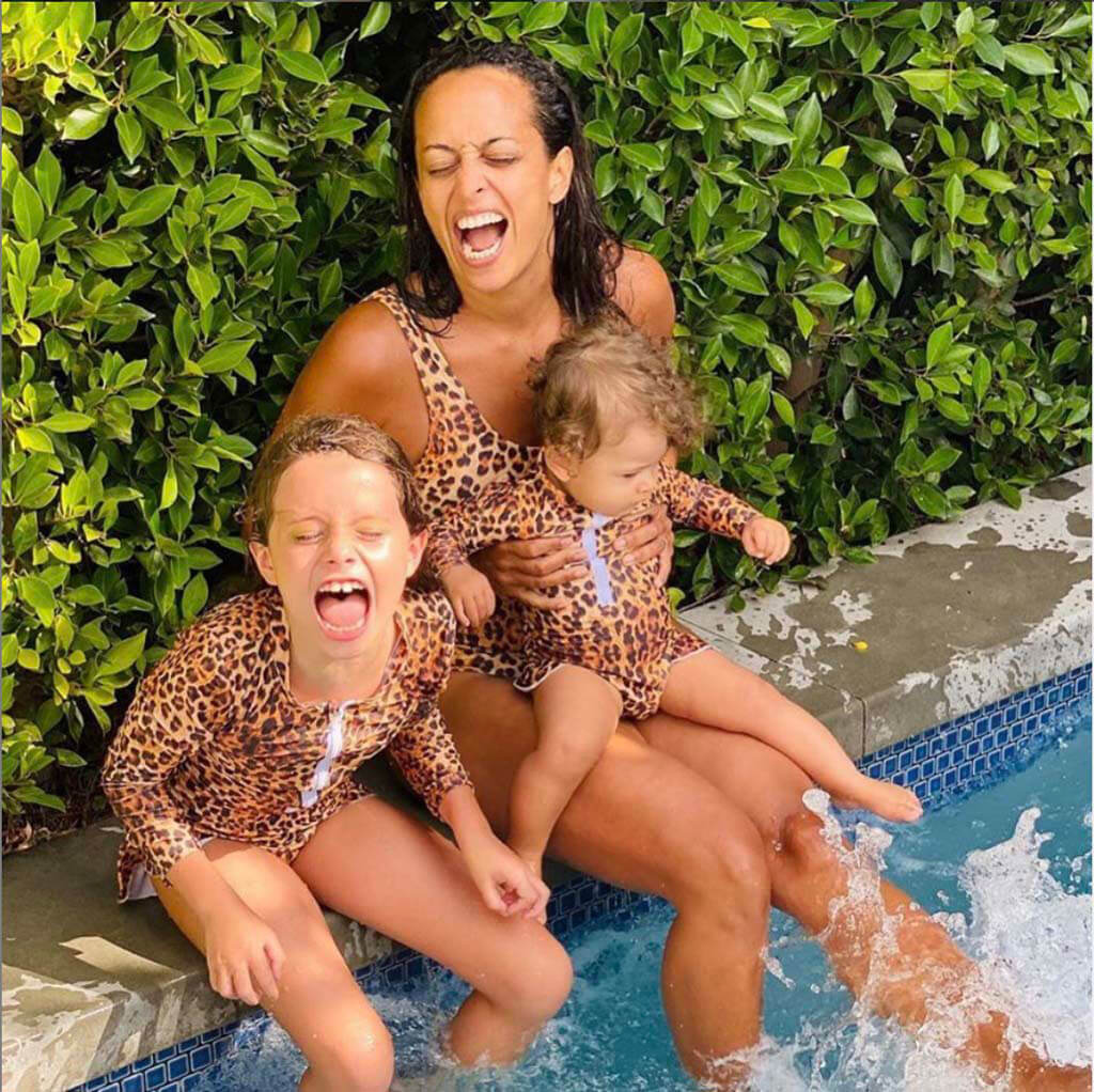 Woman Laughing While Sitting By Pool Wearing Leopard Print Women's One Piece Swimmers