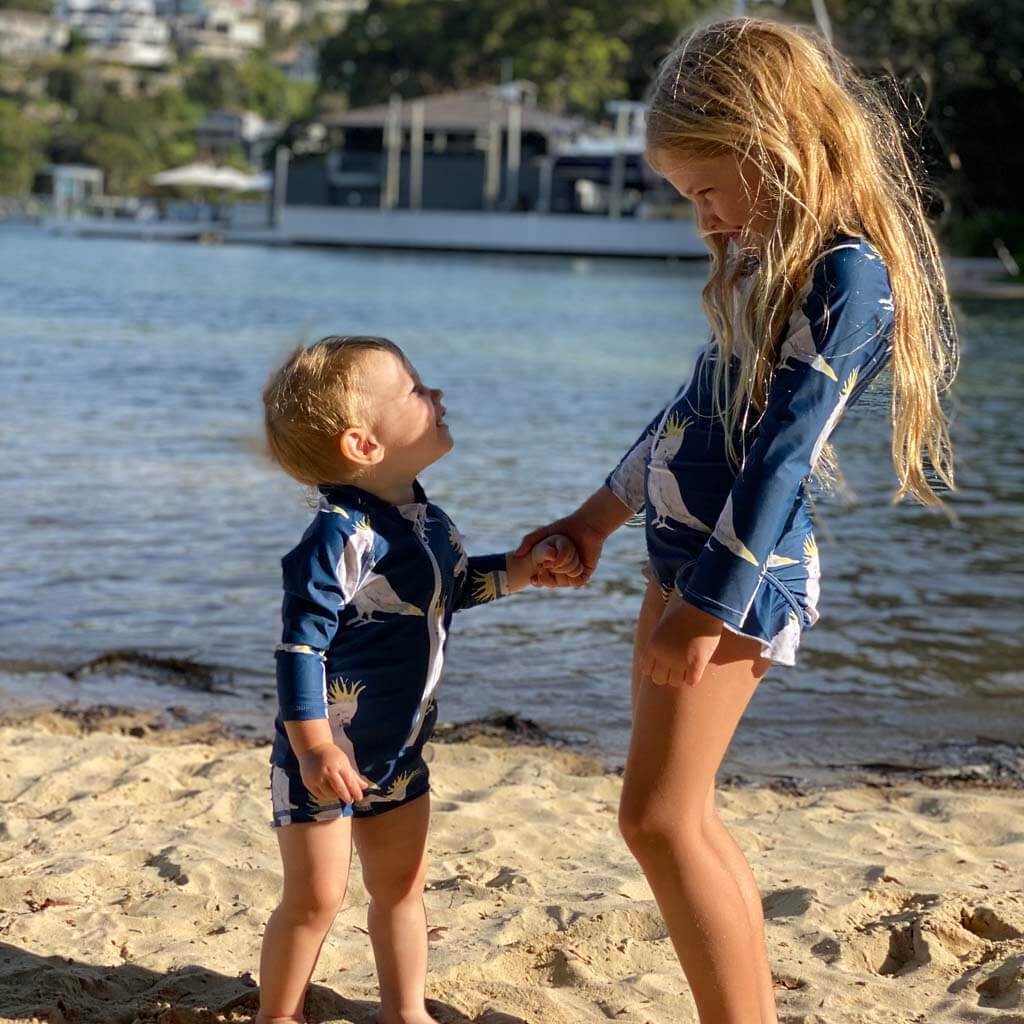 Toddler With Big Sister Wearing Navy Cockatoo Unisex Long Sleeve Zip Swimmers