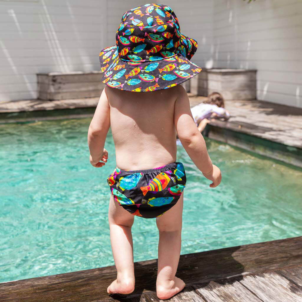 Toddler Wearing Neon Fish Beach Hat While At Pool