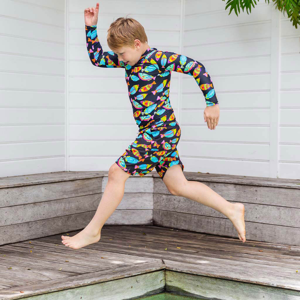 Boy Leaping Wearing Neon Fish Kids' Rash Top